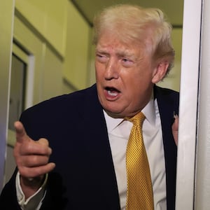 IN FLIGHT - JANUARY 04:  U.S. President Donald Trump, Commerce Secretary Howard Lutnick (L) and U.S. Sen. Lindsey Graham (R-SC) (C) speak to the media aboard Air Force One enroute to Washington, DC on January 04, 2026. Trump is returning to the White House after giving the order for the United States law enforcement to capture Venezuelan President Nicolás Maduro and his wife. (Photo by Joe Raedle/Getty Images)