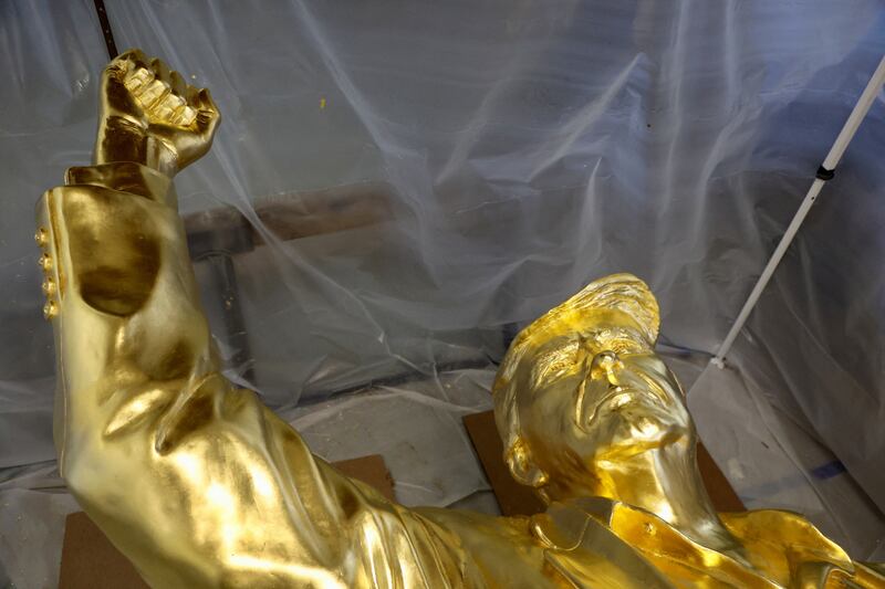 A 15-foot-tall gold-leafed bronze statue of U.S. President Donald Trump, designed by sculptor Alan Cottrill, at his studio in Zanesville, Ohio, U.S., February 10, 2026. REUTERS/Eric Cox