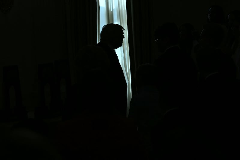 U.S. President Donald Trump is silhouetted during the NCAA Collegiate National Champions Day at the White House in Washington, DC, on April 21, 2026.