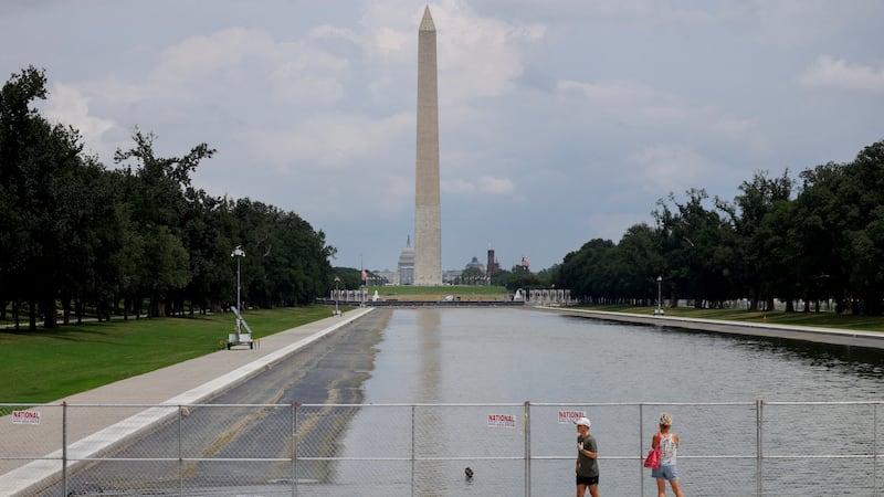 Visitors observe the Lincoln Memorial Reflecting Pool through a fence as its draining continues, following renovations and Independence Day celebrations, in Washington, D.C., U.S., July 12, 2026. REUTERS/Leah Millis     TPX IMAGES OF THE DAY