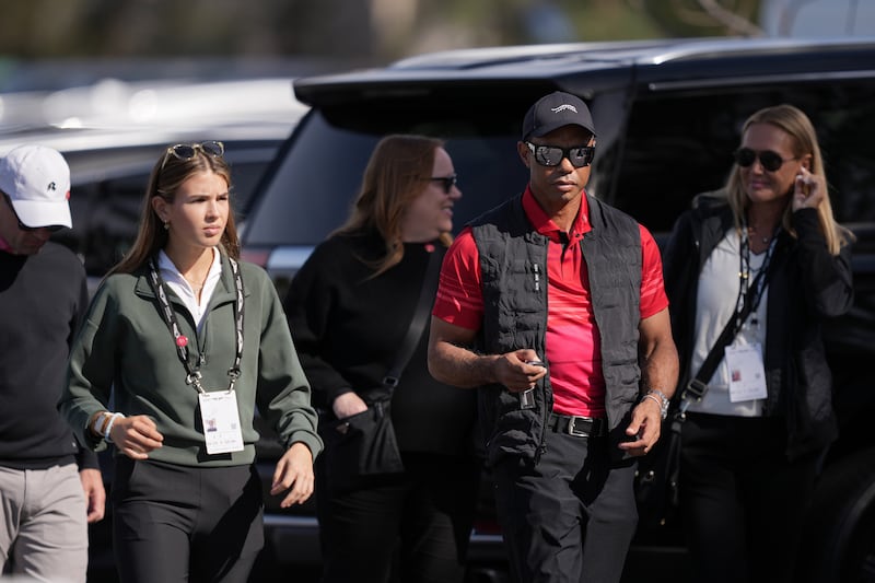 LA JOLLA, CALIFORNIA - FEBRUARY 16: Kai Trump (L) and Tiger Woods arrive to the course during the final round of The Genesis Invitational 2025 at Torrey Pines Golf Course on February 16, 2025 in La Jolla, California. (Photo by Michael Owens/Getty Images)