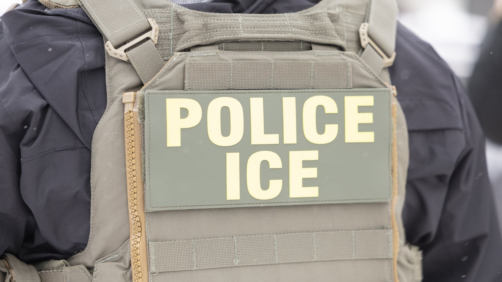 MINNESOTA, UNITED STATES - DECEMBER 10: Immigrations, Customs, and Enforcement officers question a man's status on Lake Street near a Somali mall called the Karmel Mall in Minnesota, United States on December 10, 2025. They questioned him as activists and ICE agents confronted each other. (Photo by Christopher Juhn/Anadolu via Getty Images)