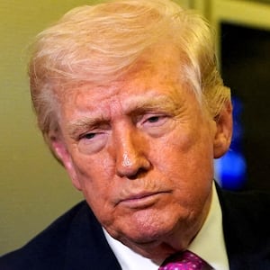 A member of the media raises her hand for a question as U.S. President Donald Trump talks while holding up renderings of the planned White House ballroom, aboard Air Force One en route to Joint Base Andrews, Maryland, U.S., March 29, 2026.