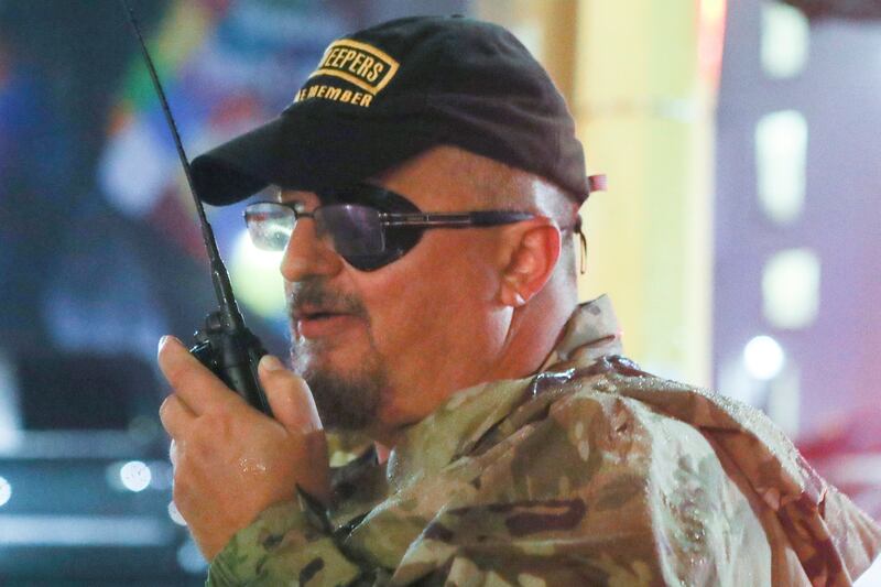 Oath Keepers militia founder Stewart Rhodes uses a radio as he departs with volunteers from a rally held by U.S. President Donald Trump in Minneapolis, Minnesota, U.S. October 10, 2019. Picture taken October 10, 2019.  REUTERS/Jim Urquhart