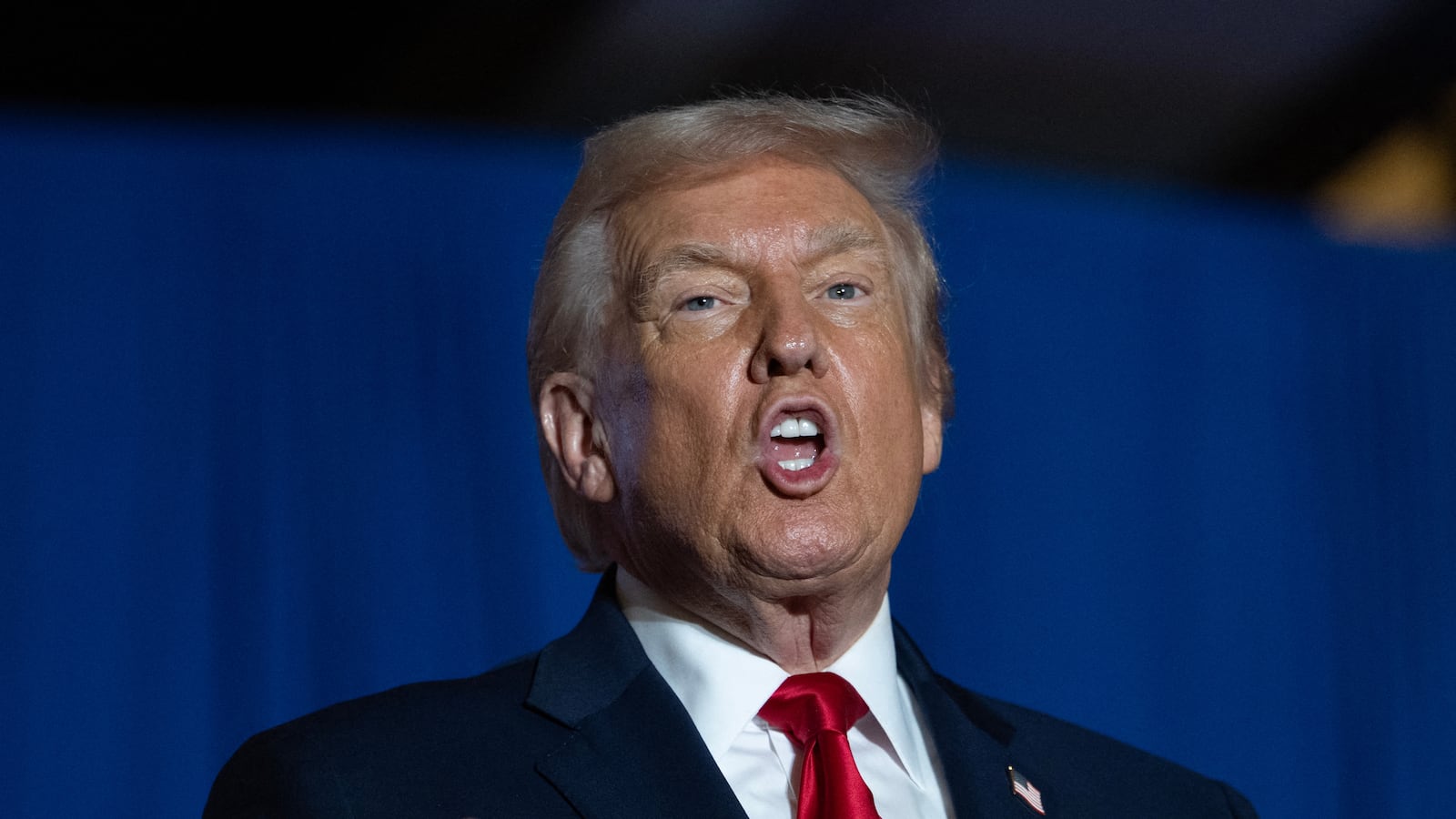 US President Donald Trump sings upon his arrival to deliver remarks on the economy at Mount Airy Casino Resort in Mount Pocono, Pennsylvania, on December 9, 2025. (Photo by ANDREW CABALLERO-REYNOLDS / AFP via Getty Images)