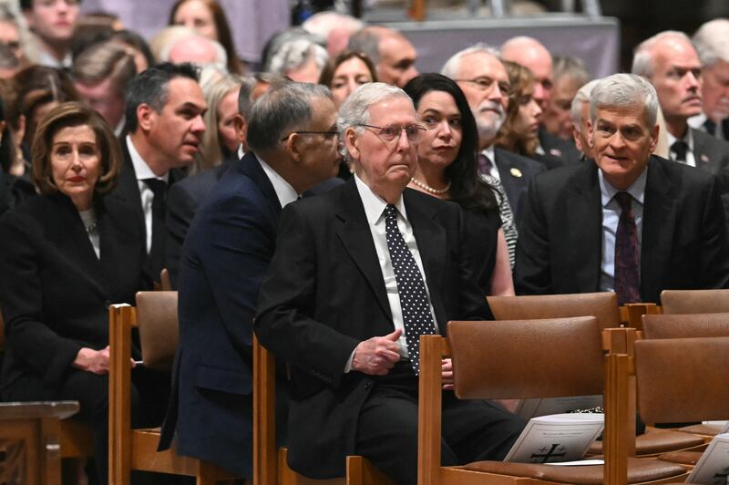 Republican Sen. Bill Cassidy, right, sat a row behind his Senate colleague Mitch McConnell at Thursday’s service.