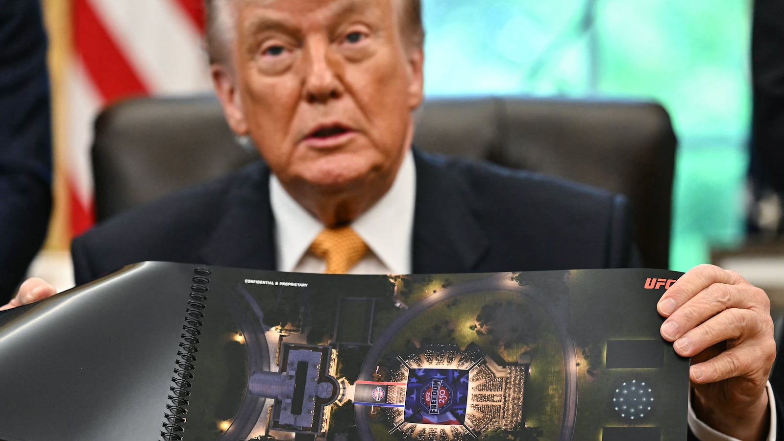 US President Donald Trump shows a rendering of the upcoming "UFC Freedom 250" event