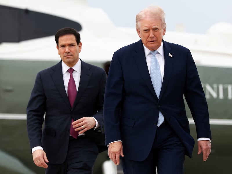 U.S. President Donald Trump walks with Secretary of State Marco Rubio to board Air Force One as he departs from Joint Base Andrews in Maryland, U.S., March 20, 2026.  REUTERS/Kevin Lamarque