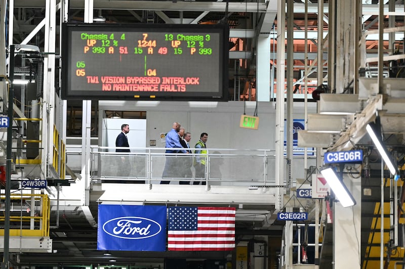 President Donald Trump, alongside L/R plant manager Corey Williams, Ford executive chairman Bill Ford and Ford CEO Jim Farley, tours Ford Motor Company's River Rouge complex in Dearborn, Michigan on January 13, 2026 where video captured him giving a worker the middle finger after being called a "pedophile protector."