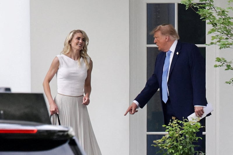 US President Donald Trump and his executive assistant Natalie Harp return from an America.gov AI event to the Oval Office at the White House in Washington, D.C., US, September 29, 2026. REUTERS/Jonathan Ernst