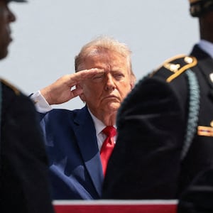 U.S. President Donald Trump salutes as members of the military carry the transfer case of U.S. Army Pvt. Isabella Gonzales of the 1st Battalion, 57th Air Defense Artillery Regiment, 52nd Air Defense Artillery Brigade, 10th Army Air Missile Defense Command, who was killed during an attack at Muwaffaq Salti Air Base in Jordan, during a dignified transfer of her remains at Dover Air Force Base in Dover, Delaware, U.S., July 22, 2026. REUTERS/Evelyn Hockstein      TPX IMAGES OF THE DAY