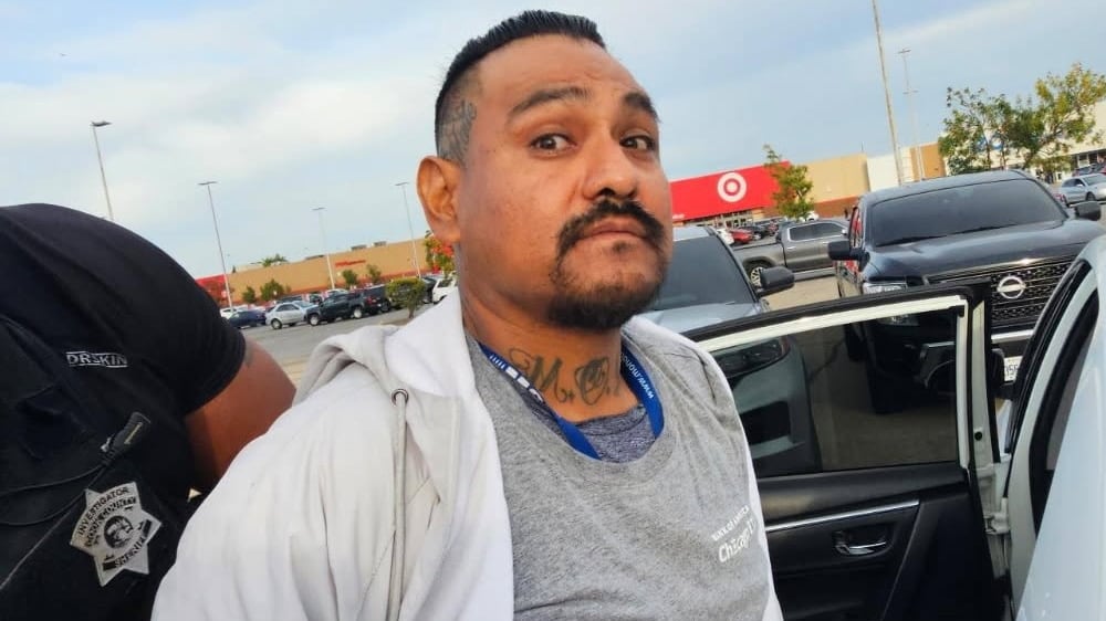 Suspect John Banuelos being detained.