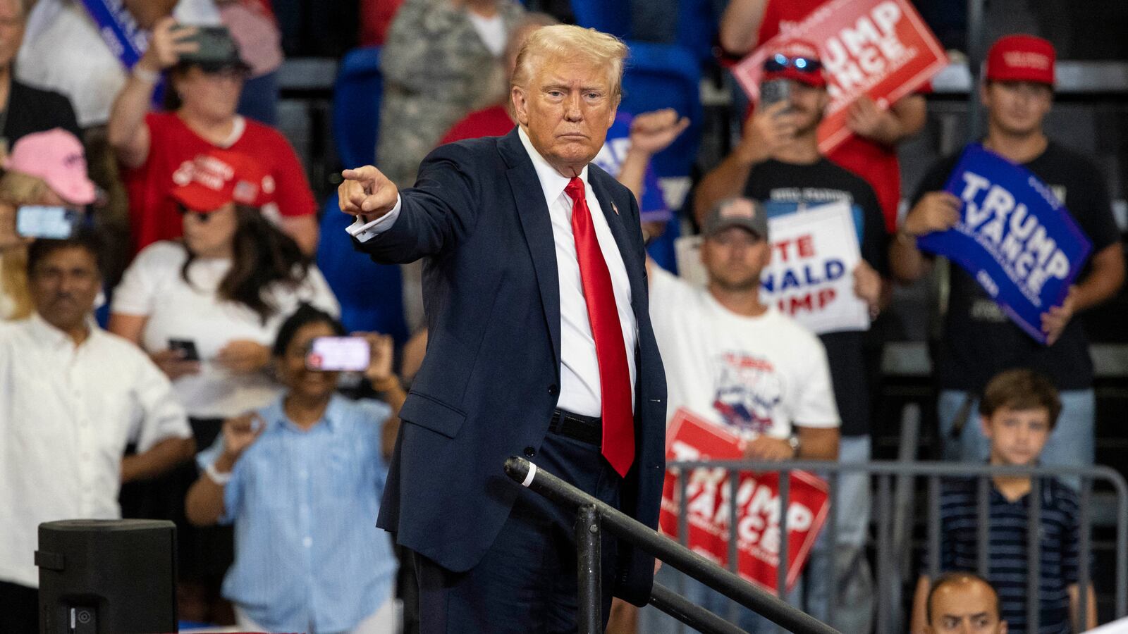 Donald Trump points to the crowd during a campaign rally at the Georgia State University Convocation Center in Atlanta, Georgia,