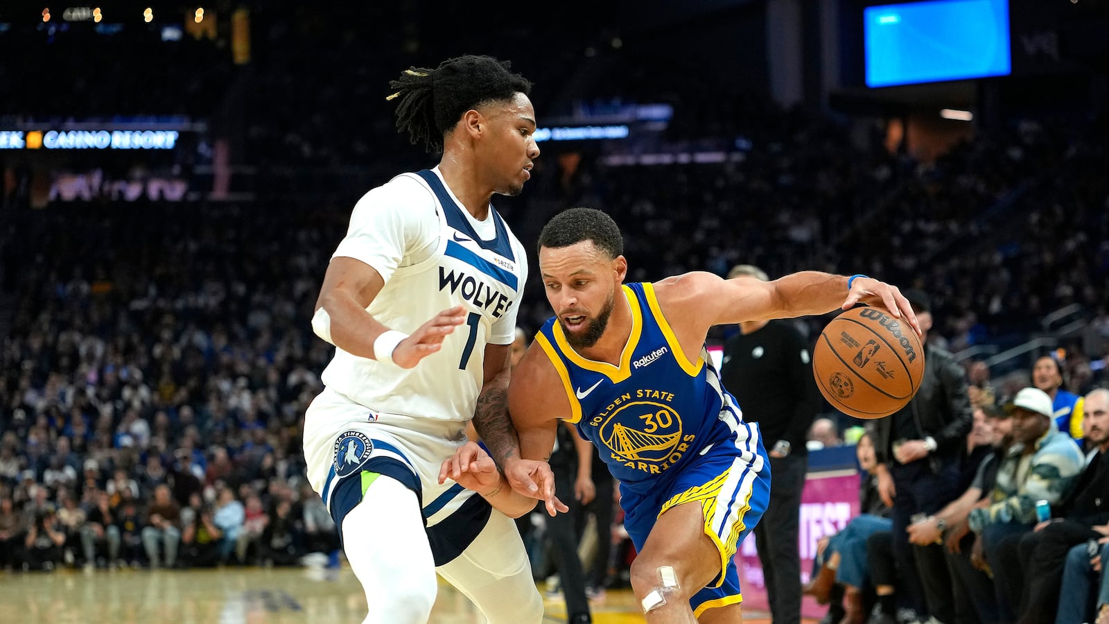 Stephen Curry #30 of the Golden State Warriors dribbling the ball is guarded by Terrence Shannon Jr. #1 of the Minnesota Timberwolves in the first half of an NBA basketball game at Chase Center on December 12, 2025 in San Francisco, California.