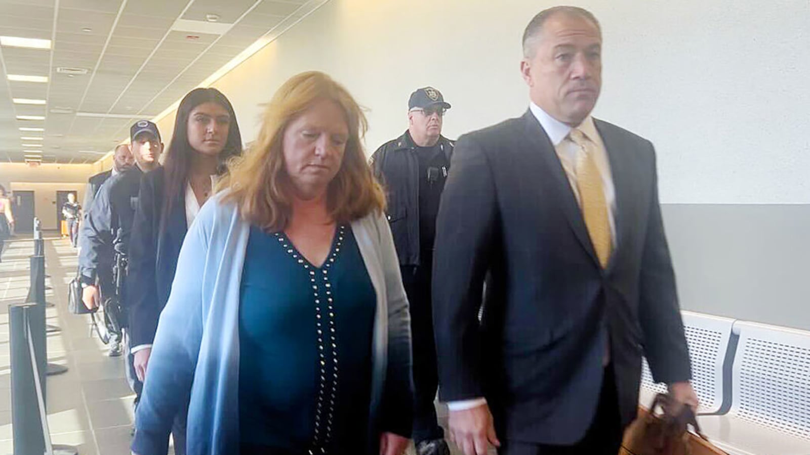 Asa Ellerup walks with her lawyers into a New York courtroom.