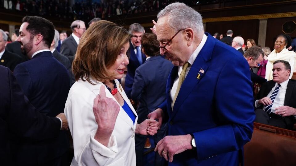 Senate Minority Leader Chuck Schumer chats with former House Speaker Nancy Pelosi on the House floor.