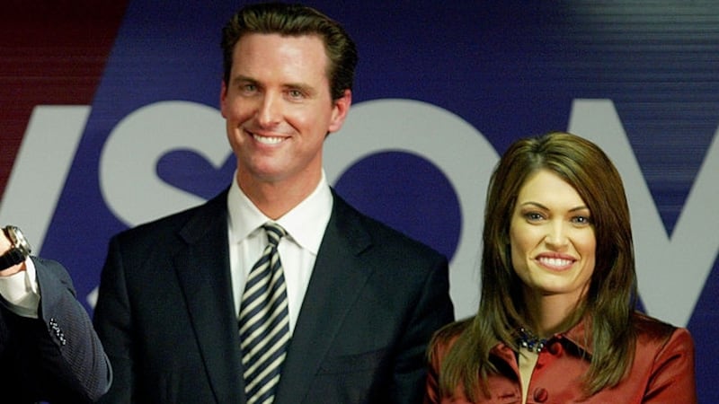 Former U.S. President Bill Clinton (L) speaks at a campaign rally for San Francisco mayoral candidate Gavin Newsom (C) as Newsom's wife Kimberly Guilfoyle-Newsom (R) looks on December 8, 2003 in San Francisco, California.