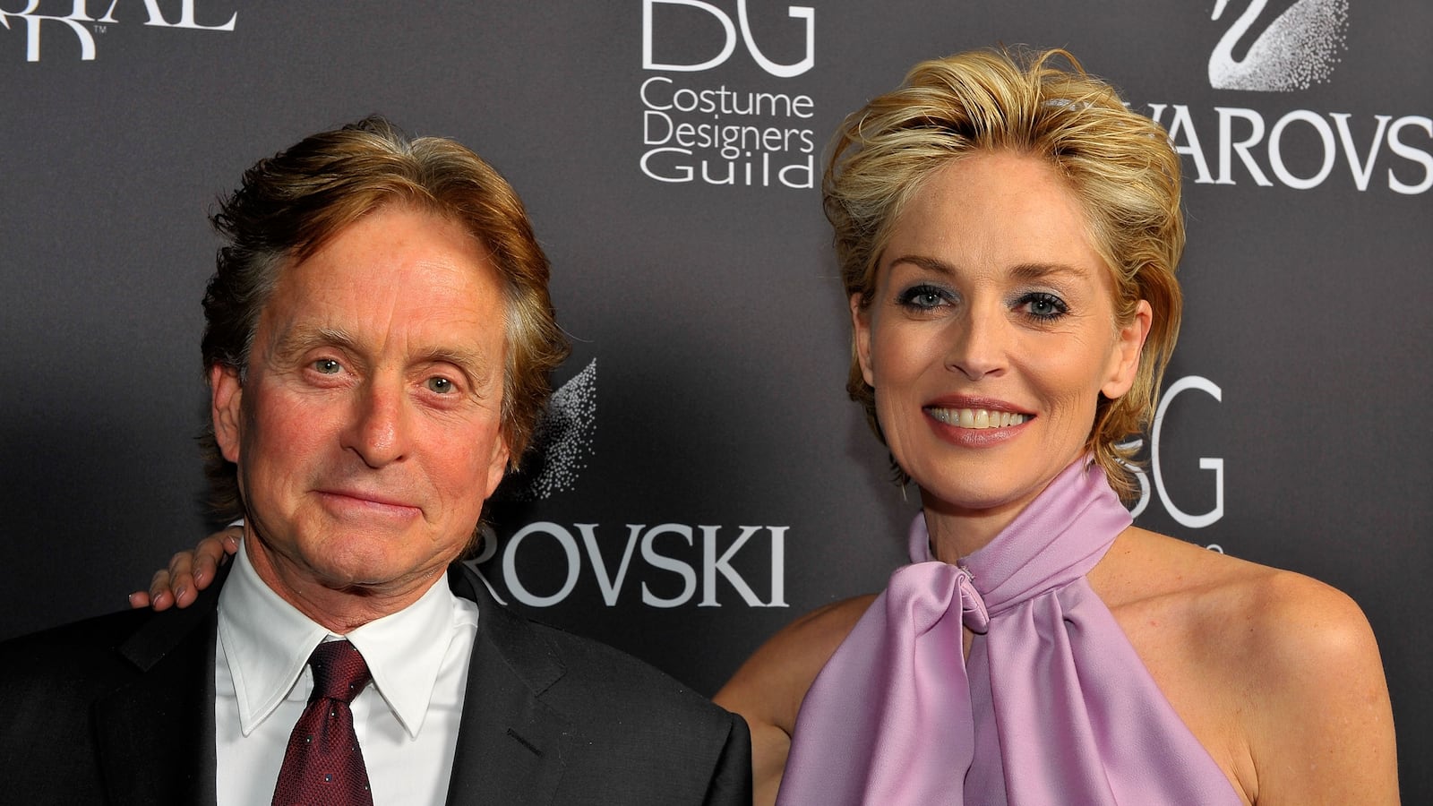 Actor Michael Douglas winner of the Swarovski President's award and actress Sharon Stone pose with the Swarovski President's award backstage during the 11th annual Costume Designers Guild Awards held at the Four Seasons Beverly Wilshire Hotel on Februray 17, 2009 in Beverly Hills, California.