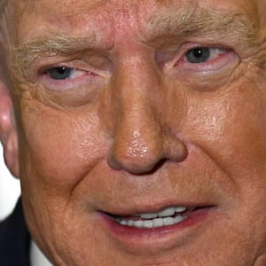 US President Donald Trump speaks with reporters aboard Air Force One on his way back to Washington, DC, on January 4, 2026. President Trump is returning to DC after spending the holidays at his Mar-a-Lago residence in Palm Beach, Florida. (Photo by Jim WATSON / AFP via Getty Images)