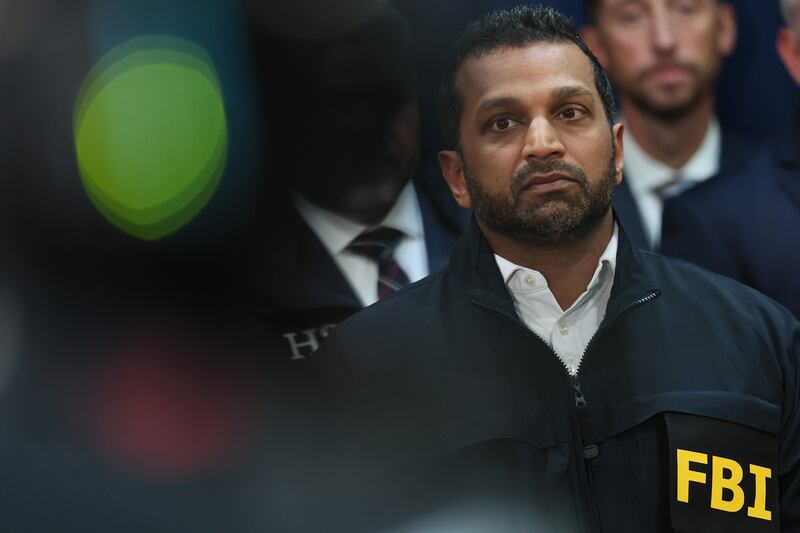 FBI Director Kash Patel stands silently during a press conference
