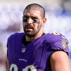 Mark Andrews, in uniform, stands on the sideline during an NFL game.