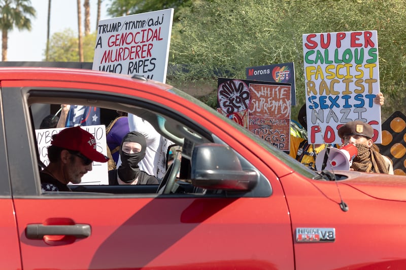 People protest the president’s visit to Arizona as attendees arrive at Dream City Church, where the Turning Point USA “Build the Red Wall” event was being held on April 17, 2026. President Trump spoke at the event by the conservative political organization founded by the late activist Charlie Kirk.