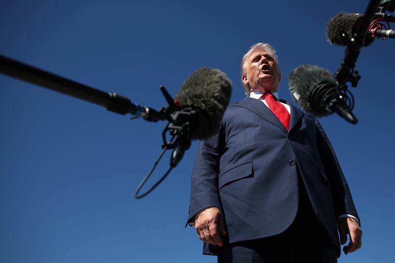 President Donald Trump speaks to reporters as he arrives at Palm Beach International Airport on October 31, 2025 to spend the weekend at his Mar-A-Lago estate in Palm Beach, Florida.