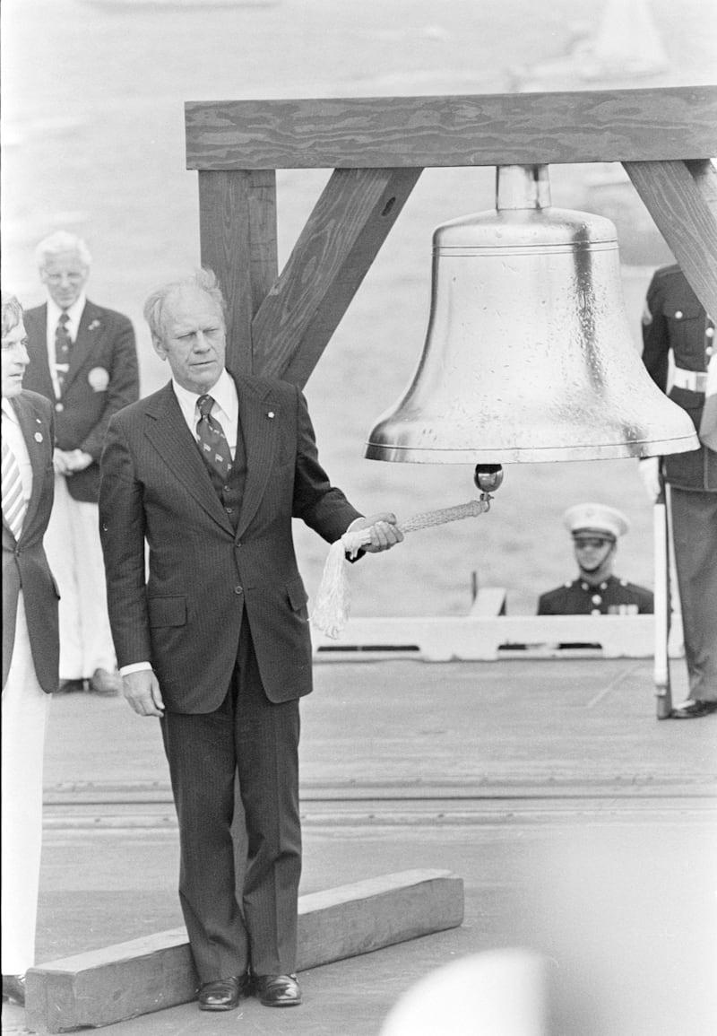 Gerald R. Ford (holding rope) attends an official bicentennial celebration in New York City, featuring a nautical parade called "Operation Sail," on July 4, 1976.