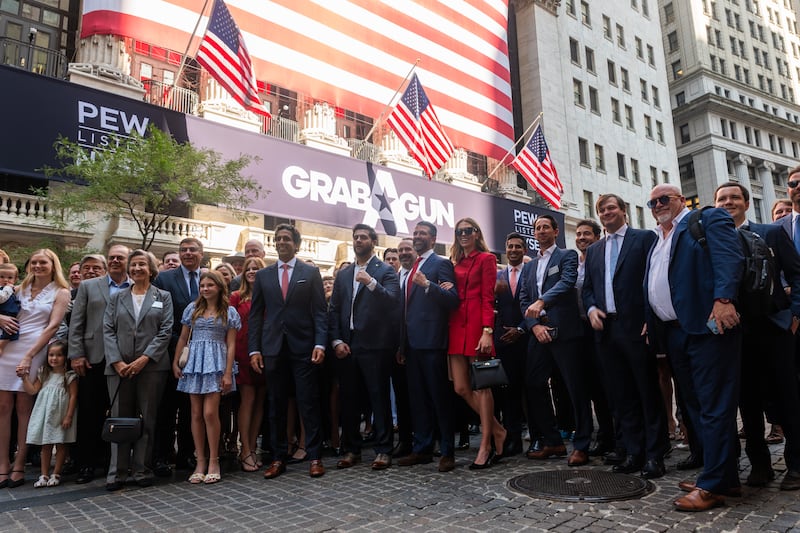 Trump Jr. posed for photos with then-girlfriend Bettina Anderson and others outside the New York Stock Exchange after taking GrabAGun public.