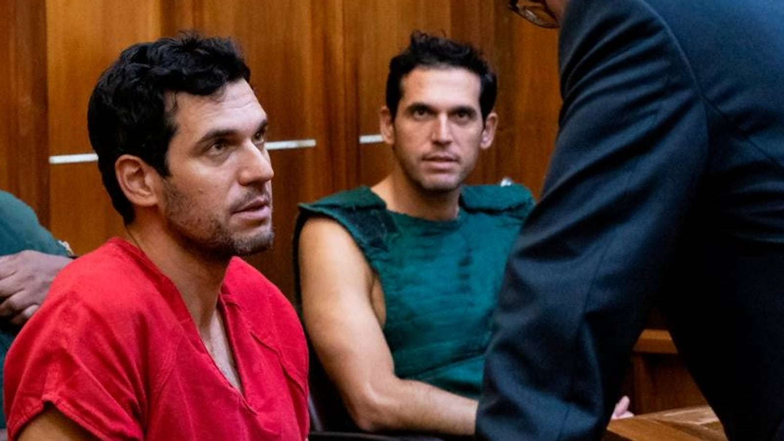 Oren Alexander, 37, center, and his twin brother, Alon, center-right, speak to their attorney Joel Denaro during their bond hearing at the Richard E. Gerstein Justice Building on Thursday, Dec. 12, 2024, in Miami, Fla. Oren, alongside his twin brother Alon Alexander, have been charged with multiple state and federal crimes, including sex trafficking and rape.