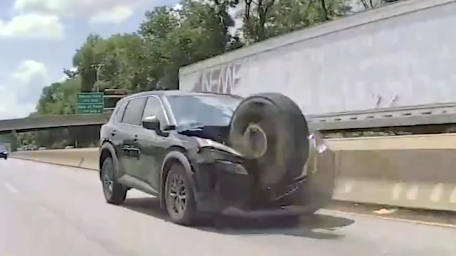 Tire crashing into the front of an SUV.