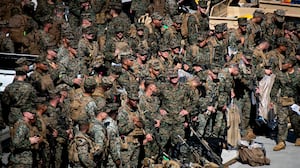 U.S. Marines with the 31st Marine Expeditionary Unit embark aboard the forward-deployed amphibious assault carrier USS Tripoli (LHA 7), at White Beach Naval Facility in Okinawa, Japan, Nov. 30, 2025.