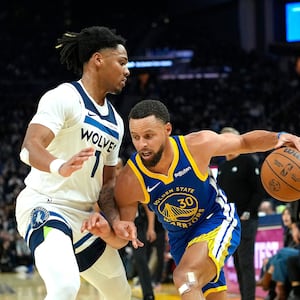 Stephen Curry #30 of the Golden State Warriors dribbling the ball is guarded by Terrence Shannon Jr. #1 of the Minnesota Timberwolves in the first half of an NBA basketball game at Chase Center on December 12, 2025 in San Francisco, California.