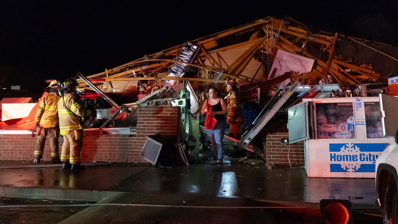 LAKE VILLAGE, INDIANA - MARCH 10: An employee emerges after being rescued from a Family Dollar store destroyed by a tornado on March 10, 2026 in Lake Village, Indiana. The National Weather Service had issued an urgent warning about a large tornado moving through the area, calling it a "life-threatening situation." (Photo by Michael Hickey/Getty Images)