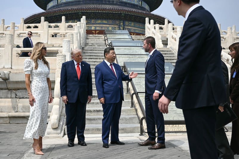 Chinese President Xi Jinping speaks with Eric Trump at the Temple of Heaven in Beijing on Thursday.