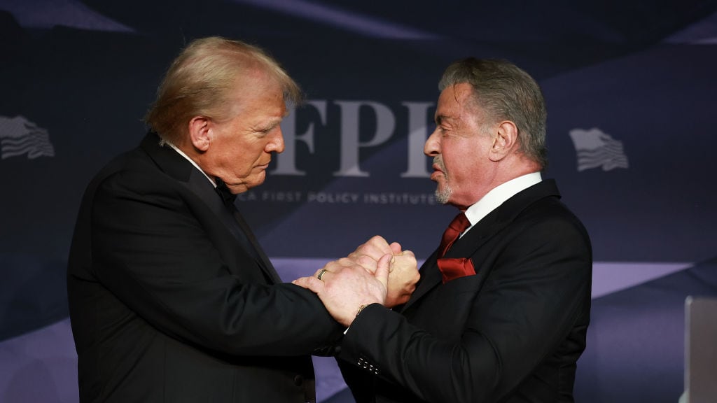 U.S. President-elect Donald Trump greets actor Sylvester Stallone onstage at the America First Policy Institute Gala held at Mar-a-Lago on November 14, 2024 in Palm Beach, Florida. The annual event supports Grey Team, a nonprofit organization dedicated to preventing military suicide.