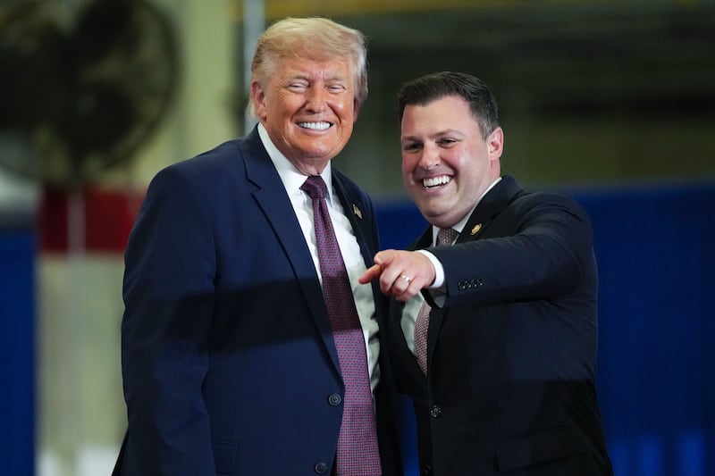 MACUNGIE, PENNSYLVANIA - JUNE 23: Rep. Congressman Ryan Mackenzie (R-PA) (R) joins U.S. President Donald Trump on stage at the Mack Trucks Lehigh Valley Operations facility on June 23, 2026 in Macungie, Pennsylvania. President Trump visited the facility to highlight American manufacturing and its benefits for local economies. (Photo by Andrew Harnik/Getty Images)