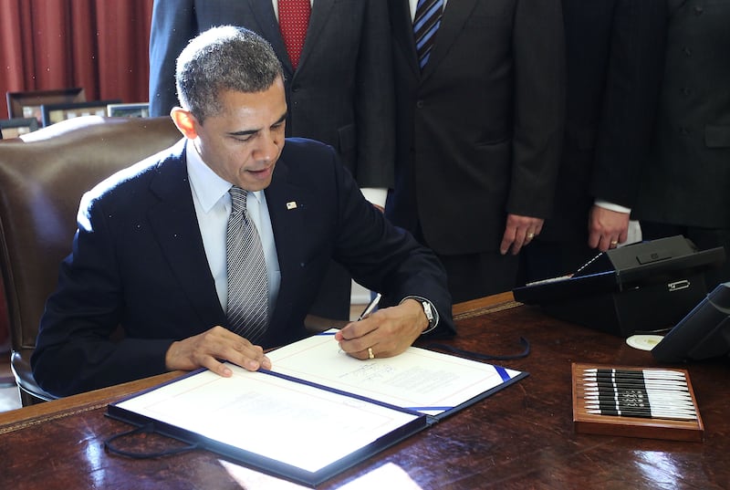 WASHINGTON, DC - DECEMBER 14:  U.S. President Barack Obama signs H.R. 6156, the Russia and Moldova Jackson-Vanik Repeal and Sergei Magnitsky Rule of Law Accountability Act, into law during an Oval Office event December 14, 2012 at the White House in Washington, DC. According to a White House news release, the bill "authorizes the President to extend Russia and Moldova with Permanent Normal Trade Relations and will sanction persons who are responsible for gross violations of human rights in Russia."  (Photo by Alex Wong/Getty Images)