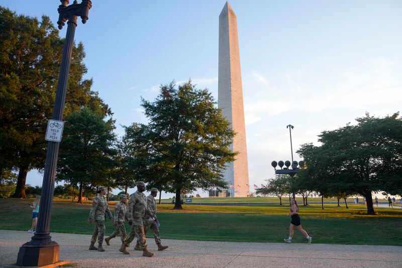 National Guard troops walk along the National Mall on August 12, 2025 in Washington, DC.