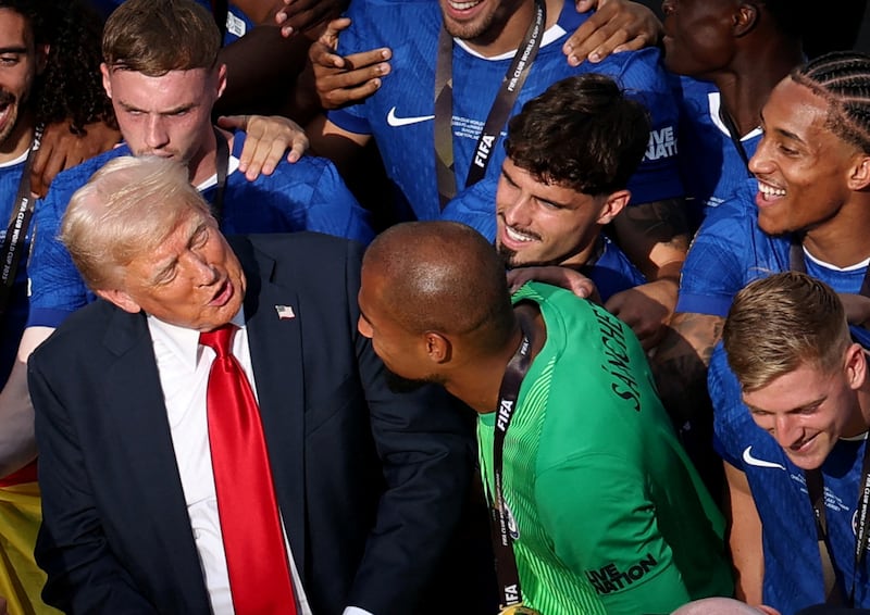 Soccer Football - FIFA Club World Cup - Final - Chelsea v Paris St Germain - MetLife Stadium, East Rutherford, New Jersey, U.S. - July 13, 2025 U.S. President Donald Trump speaks with Chelsea's Robert Sanchez as his teammates celebrate after winning the FIFA Club World Cup REUTERS/Amanda Perobelli