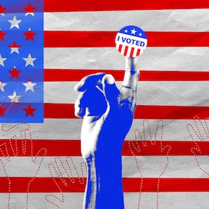 A black hand holding up an "I Voted" sticker