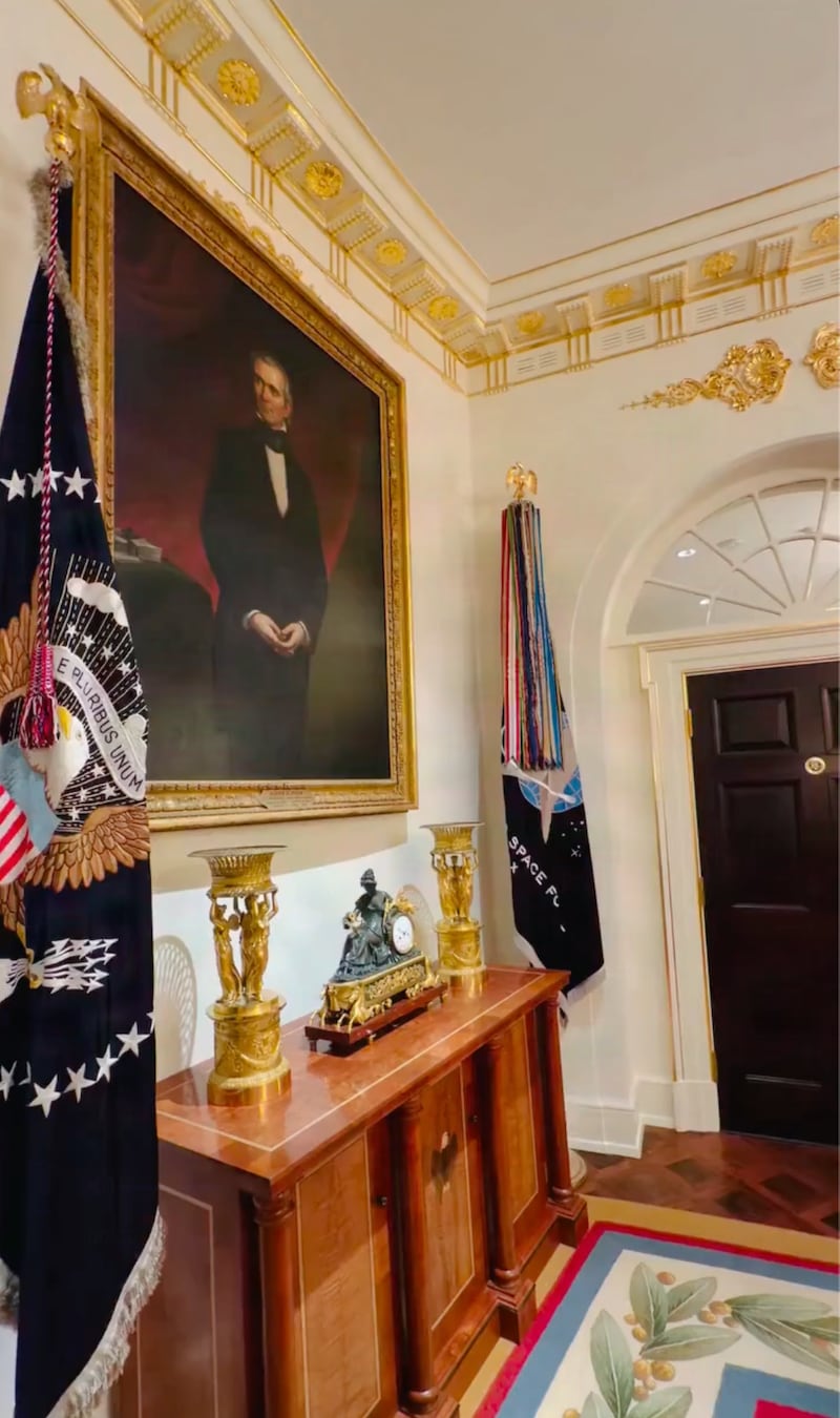 A portrait of former President James K. Polk hangs in the Cabinet Room. Below it, Trump added a pair of gold trophies to sit atop a cabinet.