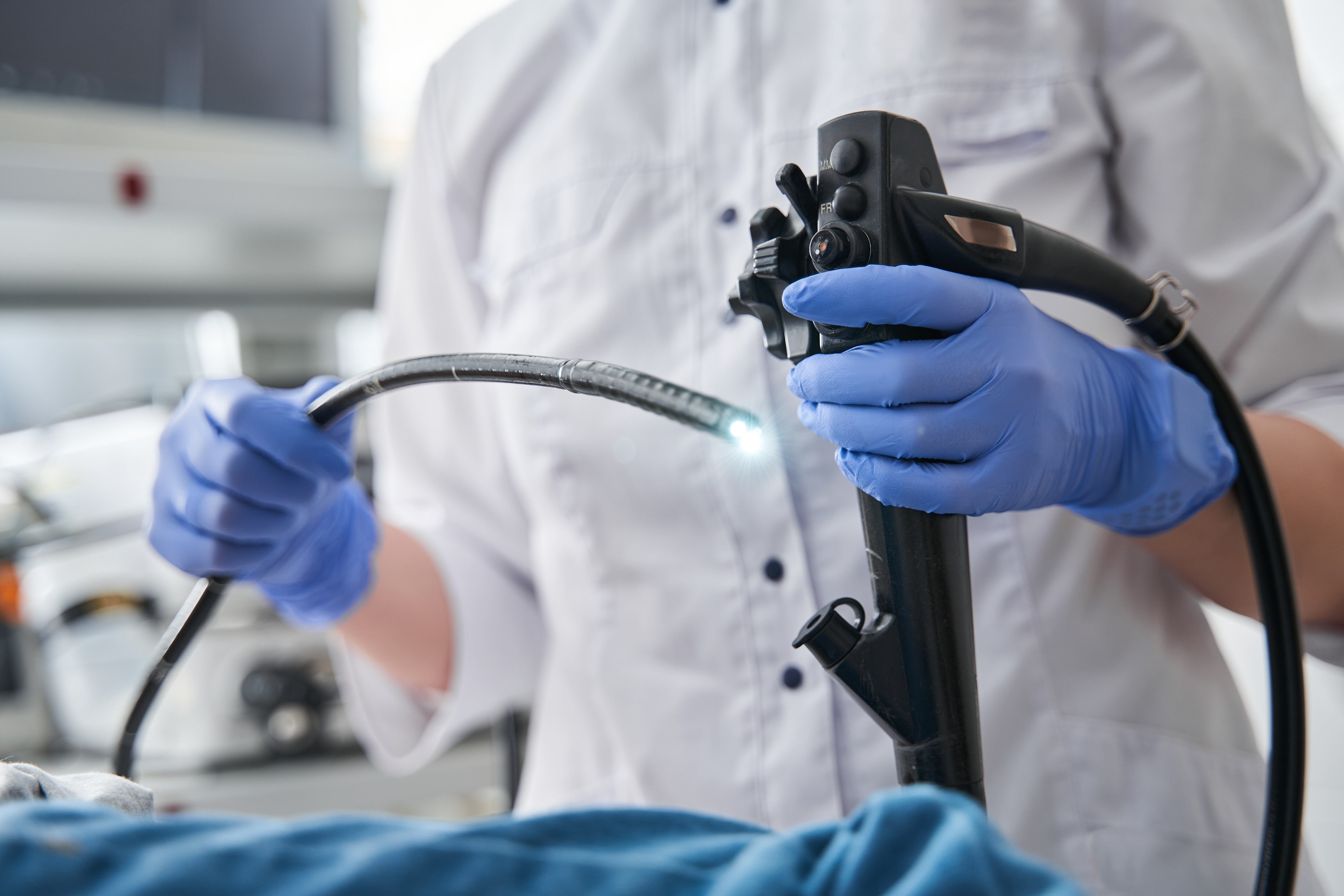 A doctor holding an endoscope during gastroscopy.