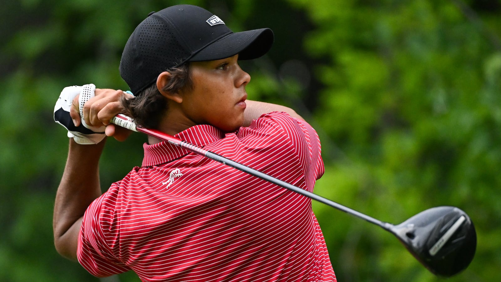 Charlie Woods golfing