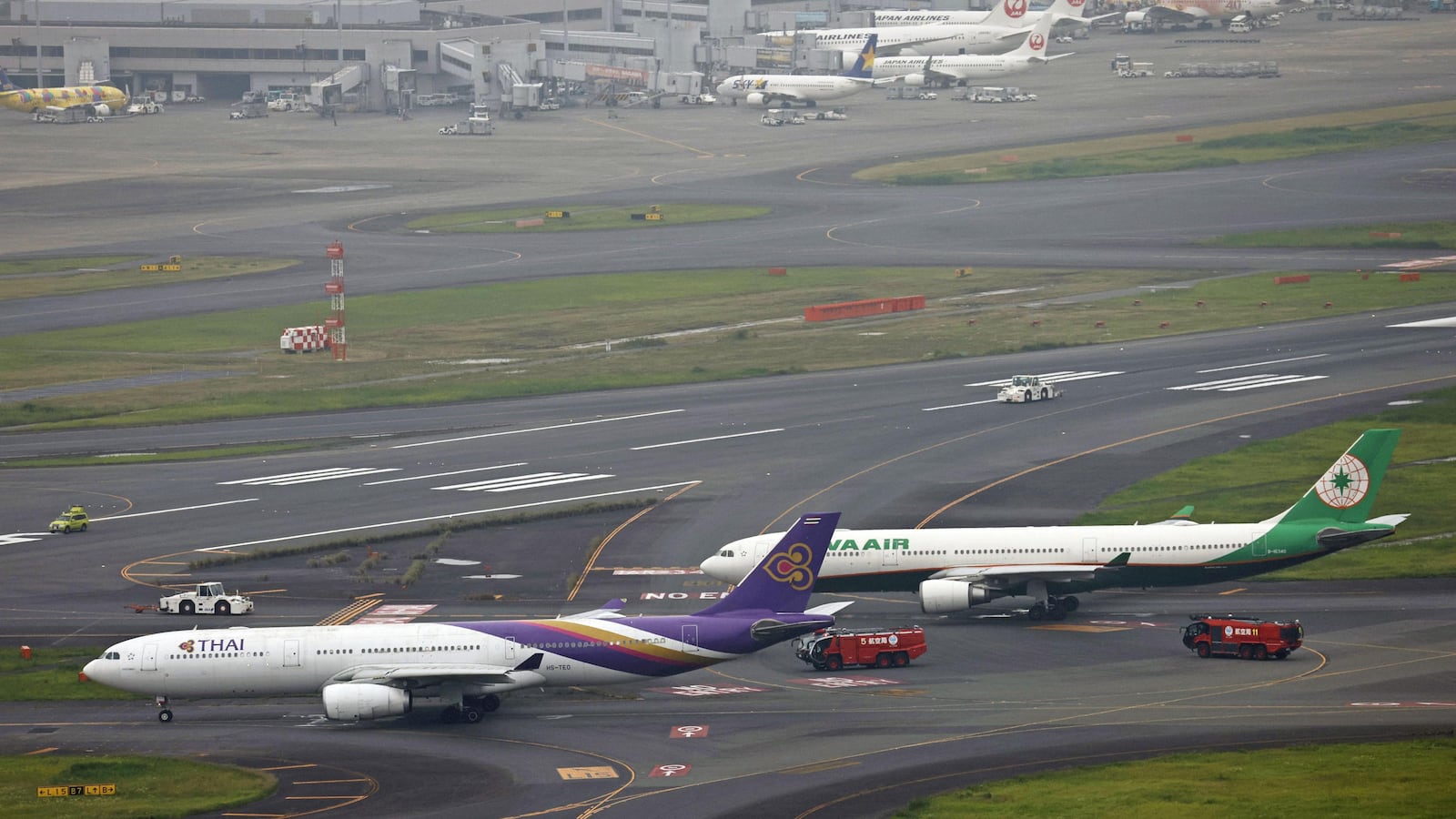 An aerial view shows Thai Airways and Eva Air aeroplanes on a taxiway after making contact at Haneda Airport, in Tokyo, Japan, June 10, 2023.