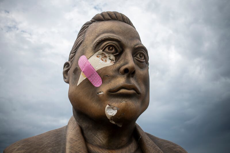 This photo taken on May 28, 2025 shows a damaged bust of Elon Musk with a plaque reading "Elon aka MemeLord by ElonRWA on BASE" outside Brownsville, Texas. (Photo by SERGIO FLORES / AFP) / RESTRICTED TO EDITORIAL USE - MANDATORY MENTION OF THE ARTIST UPON PUBLICATION - TO ILLUSTRATE THE EVENT AS SPECIFIED IN THE CAPTION (Photo by SERGIO FLORES/AFP via Getty Images)