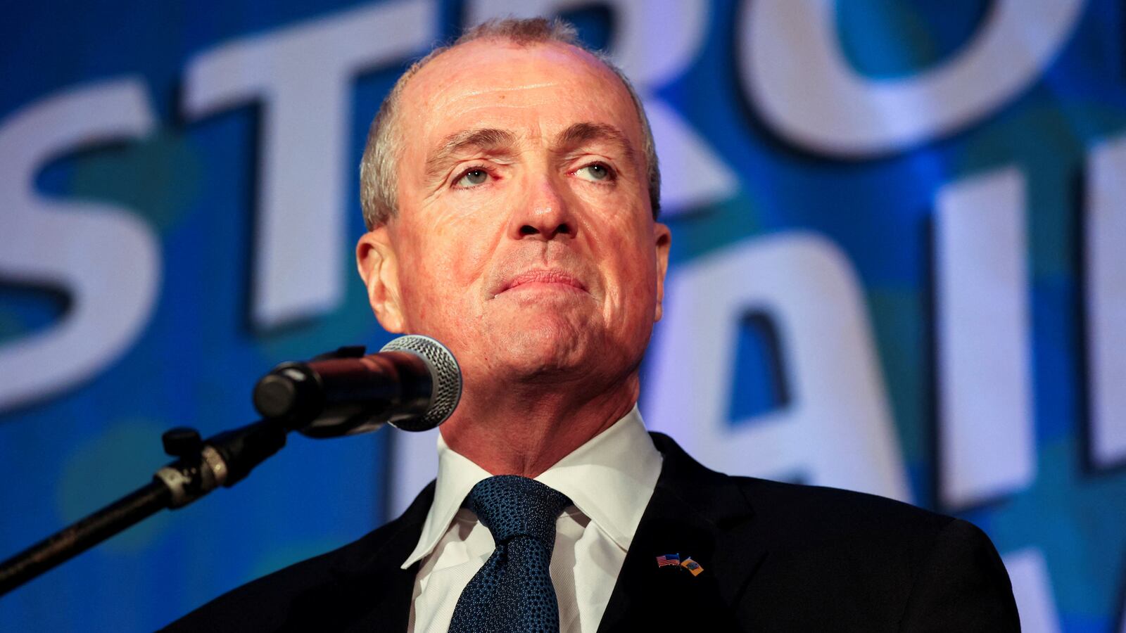 Gov. Phil Murphy looks stoic as he gives a speech.