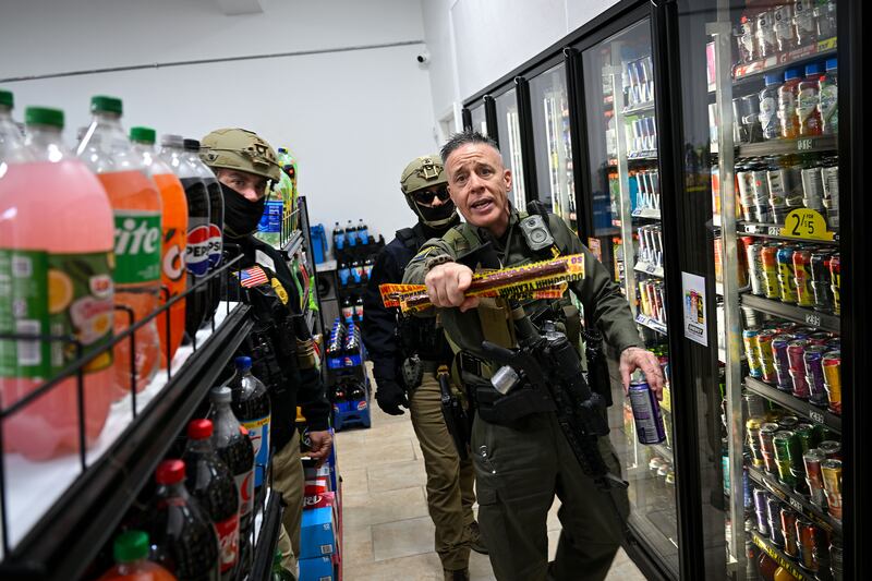U.S. Border Patrol Chief Gregory Bovino picks up snacks.