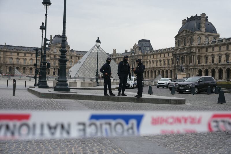 French police officers patrol in front of the Louvre Museum in Paris after it was robbed on October 19, 2025.