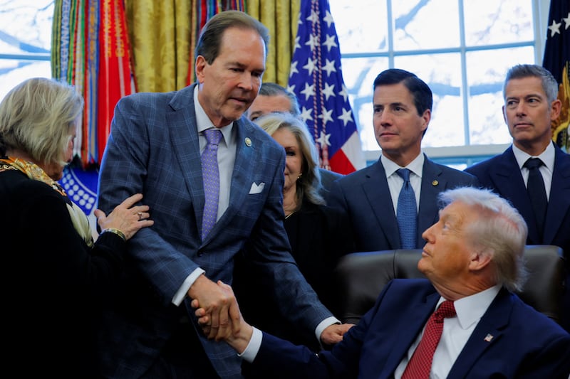 U.S. Rep. Vern Buchanan (R-FL) and President Donald Trump shake hands during the announcement of new fuel economy standards, in the Oval Office at the White House in Washington, D.C., U.S., December 3, 2025.